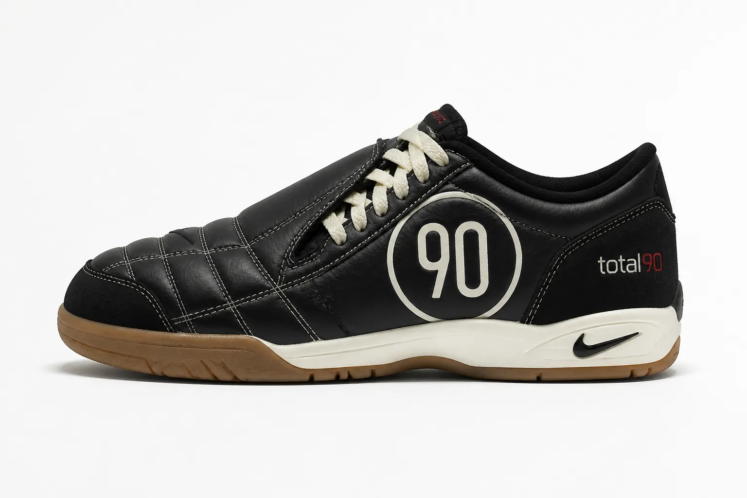 Clean product shot of the Nike Total 90 in classic black colorway, displayed on white background with subtle shadows showing quilted upper and lacing