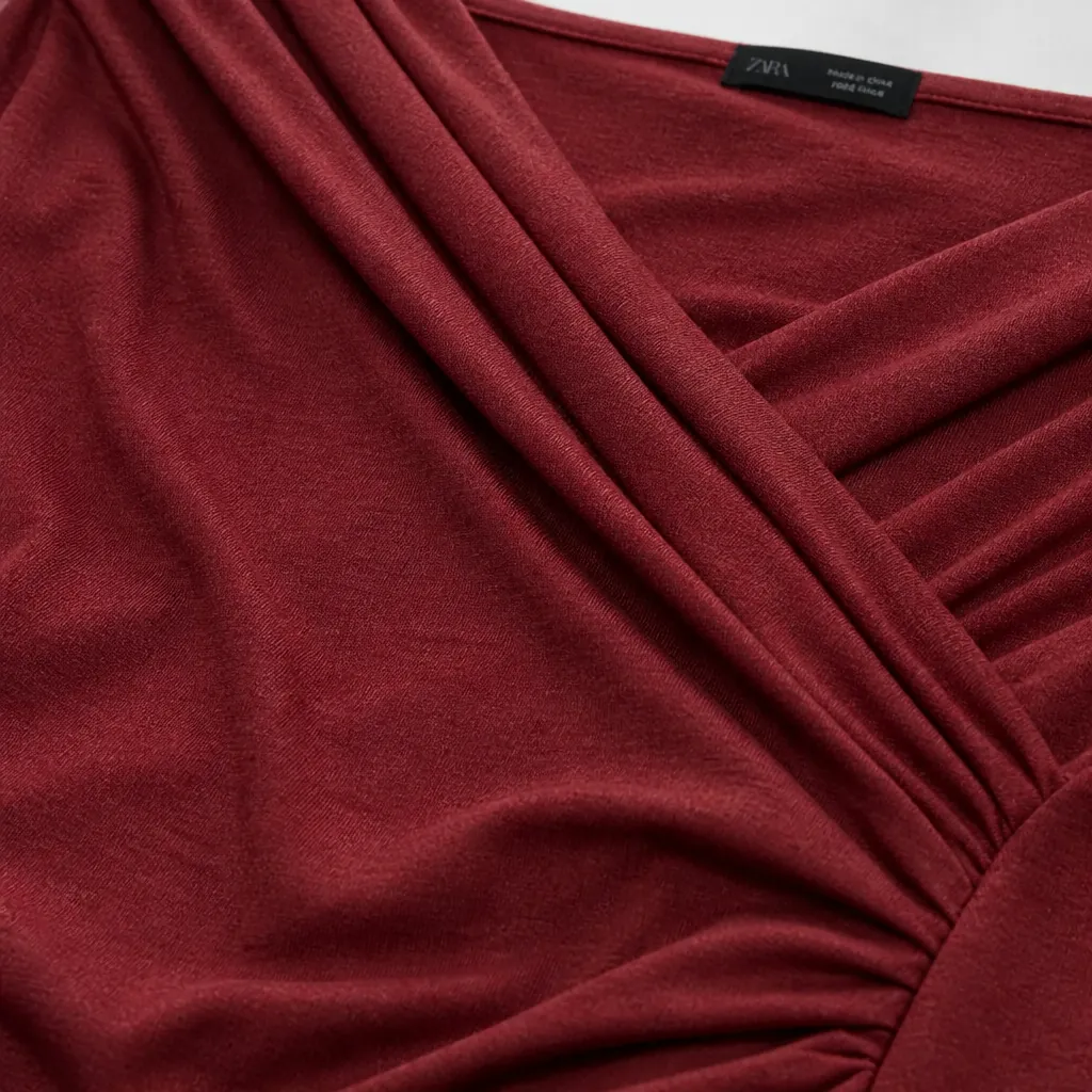 Macro close-up of premium blended fabric texture showing soft drape quality and material sheen