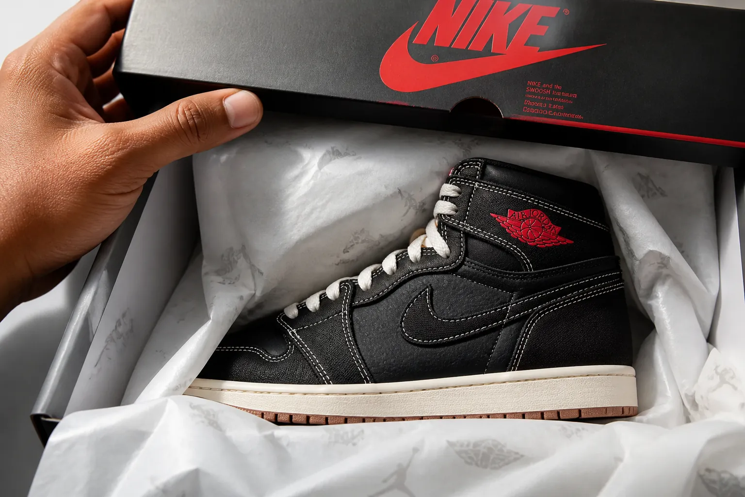 Close-up of Jordan shoebox lid being lifted revealing the iconic Air Jordan 1 Flight Club with premium tissue paper and branding