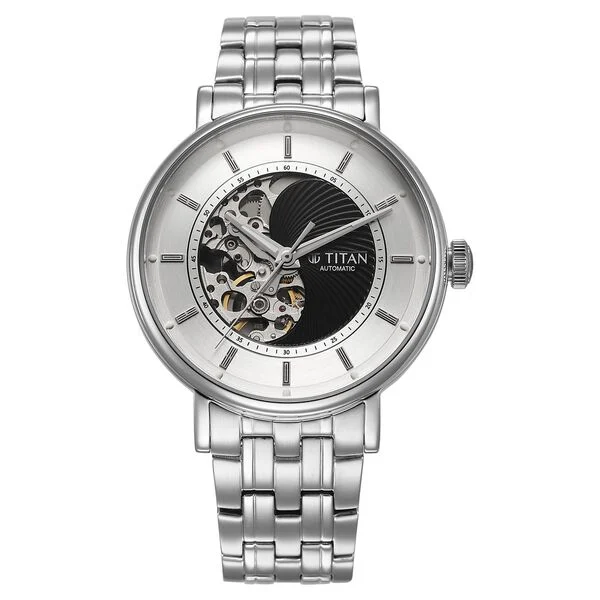 Hero product photo of the Titan Yin-Yang Skeletal Automatic watch in silver stainless steel resting at a three-quarter angle on soft neutral surface, sharp steel reflections visible