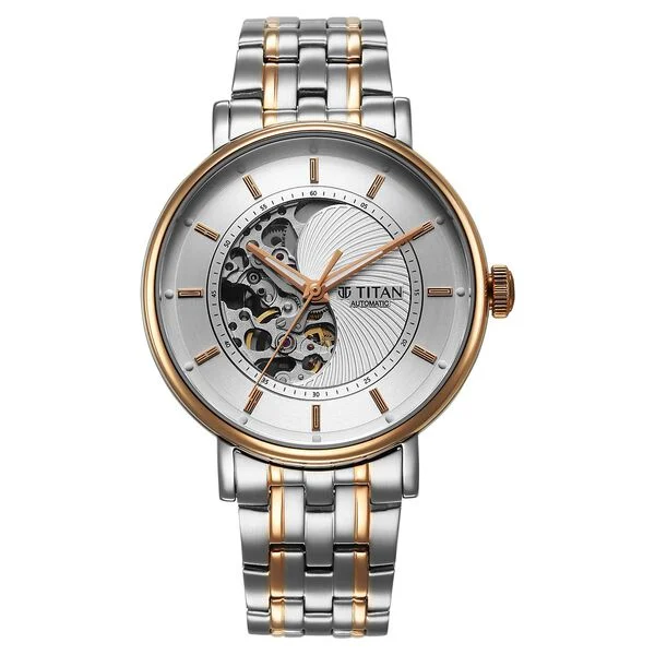 Silver and gold two-tone Titan Yin-Yang Skeletal Automatic on a display stand with warm golden accents catching the light