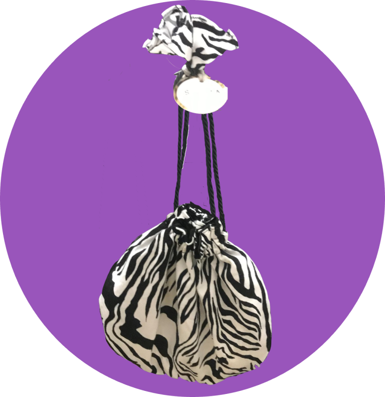 Bold animal print cinch bag with rich earthy tones and dynamic print, featuring a drawstring cinch closure with natural rope detail