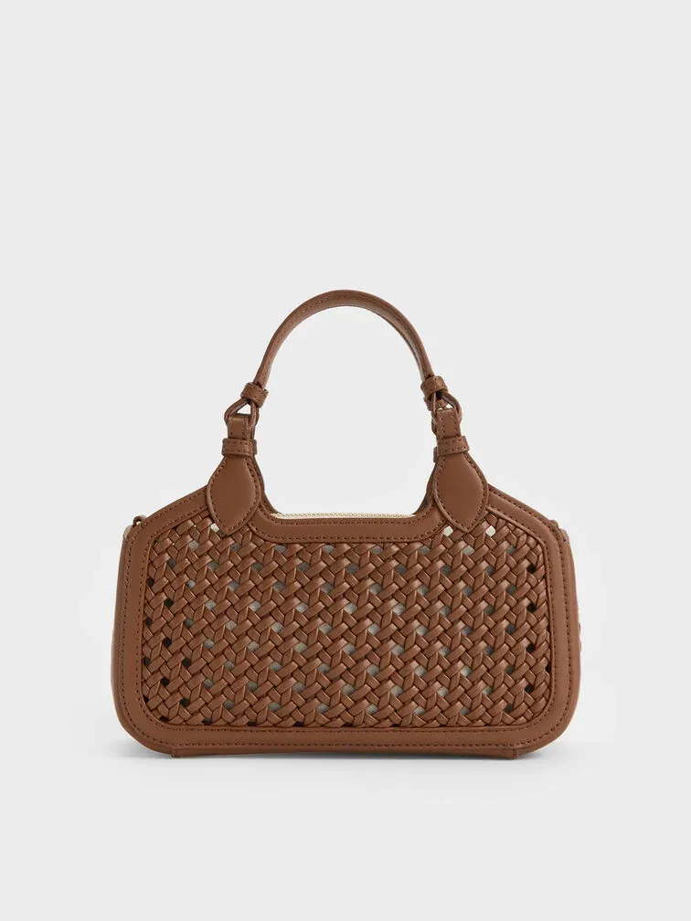 Stylish beach-ready look with a sheer white beach cover-up over a swimsuit, oversized sunglasses, and the Mini Azure tote filled with beach essentials on golden sand