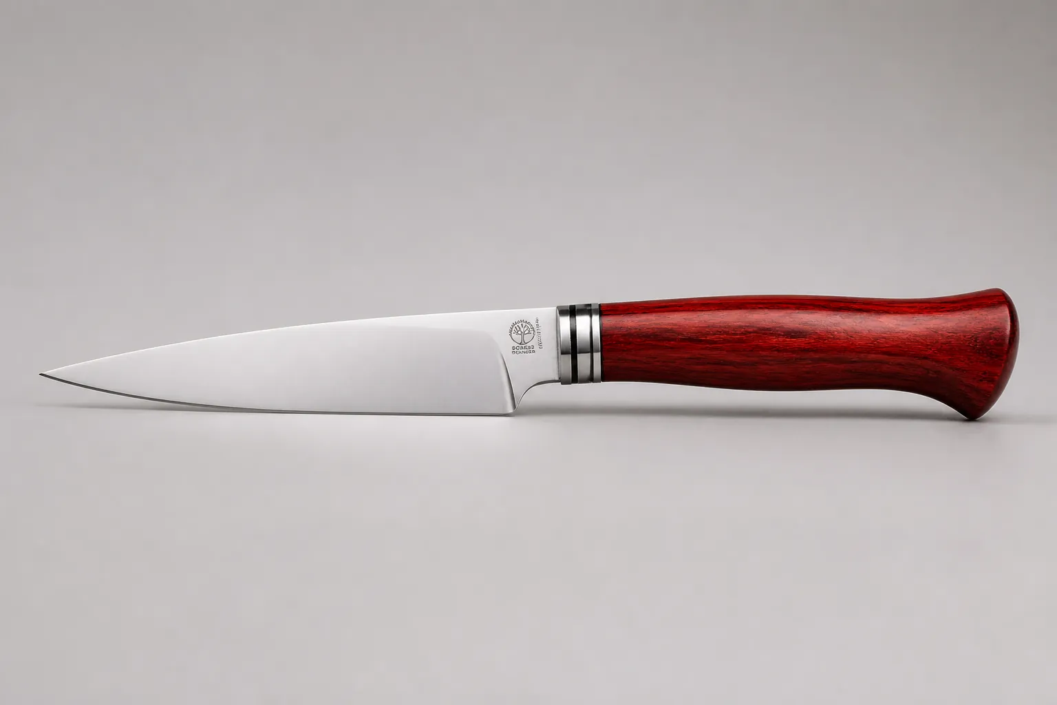 Side profile view of the complete knife showing the balanced weight distribution and elegant red handle with professional blade