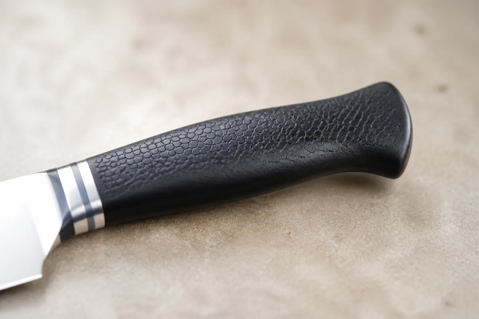 Close-up macro shot of the knife handle showing the premium anti-slip textured grip surface designed for maximum control during extended use