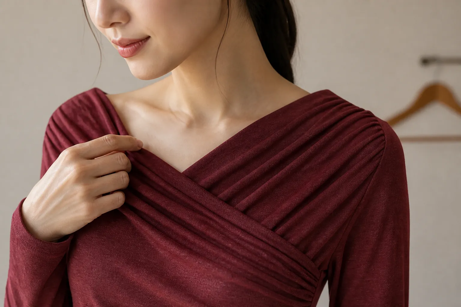 Close-up detail shot of elegant surplice neckline showing the flattering V-shape drape and smooth fabric texture