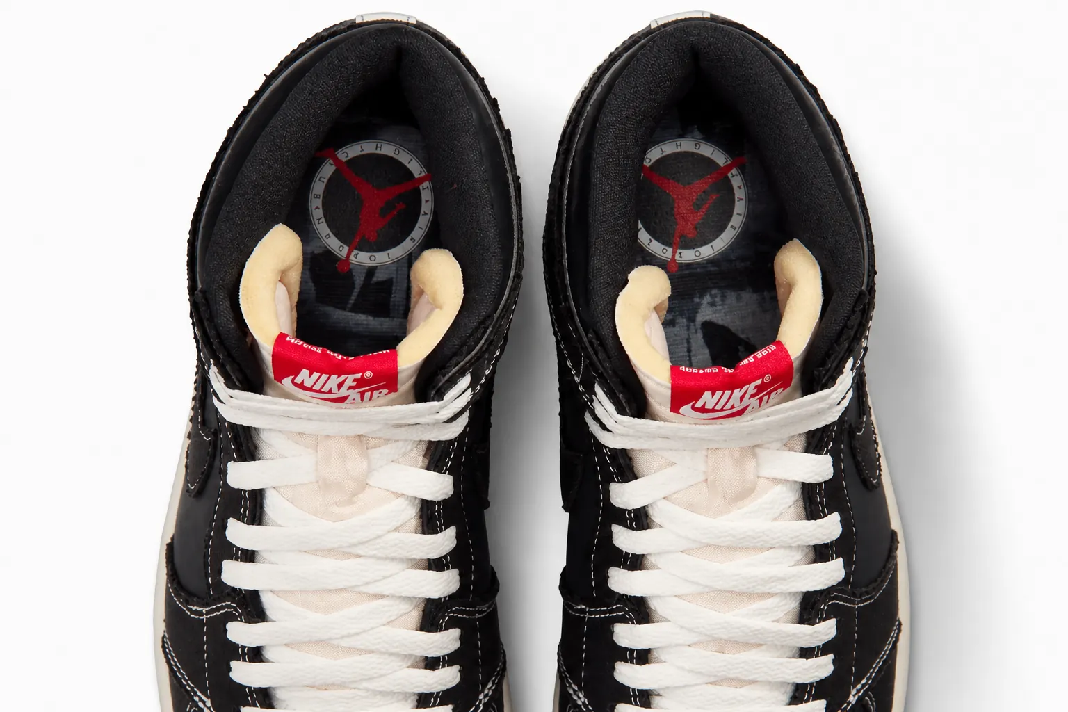 Detail shot of Air Jordan 1 showing crisp white and University Red accents on black base with sharp color blocking and Jumpman logo visibility