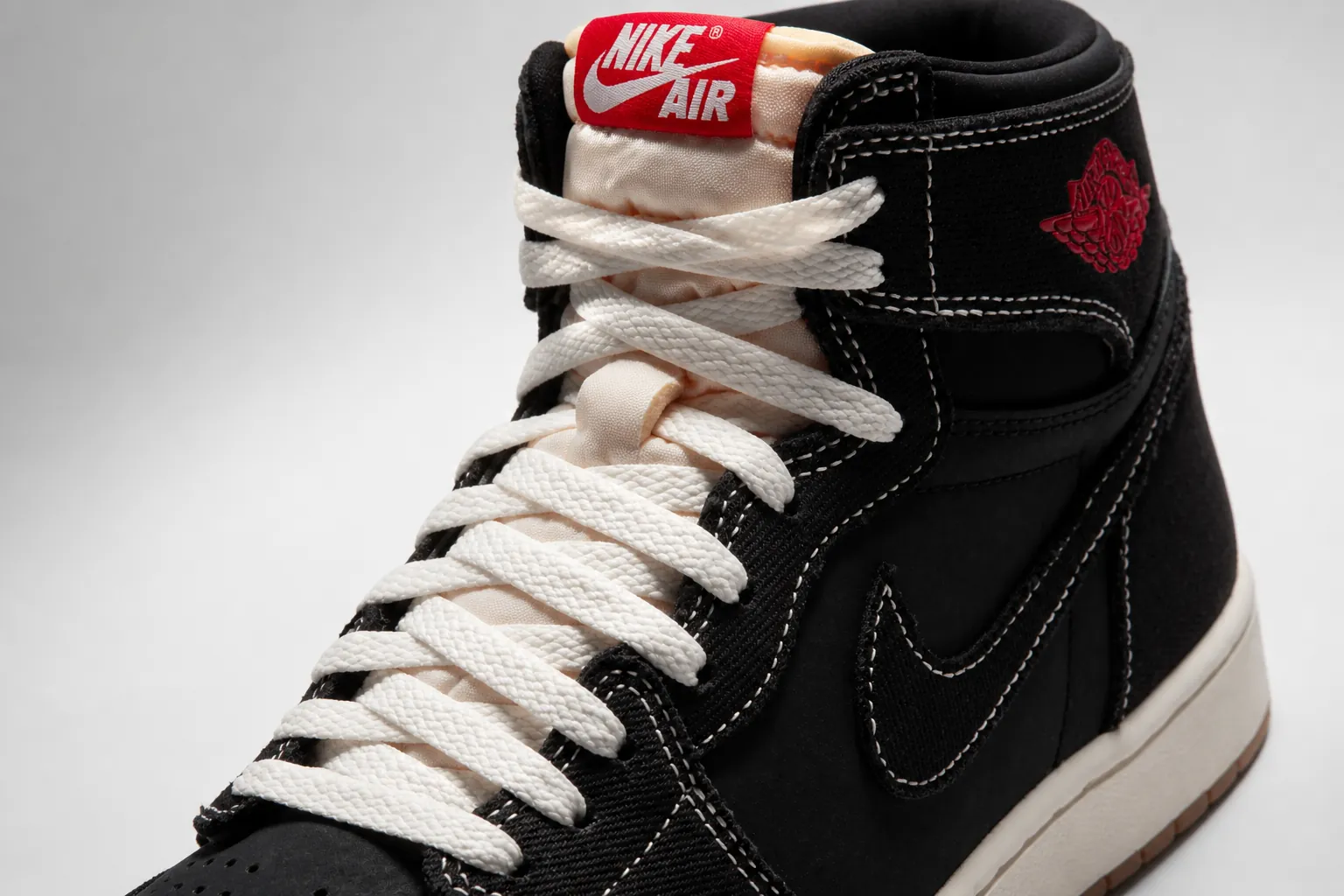 Powerful hero shot of Air Jordan 1 High OG Flight Club with dramatic emotional lighting, featuring the black woven textile upper and University Red accents prominently displayed