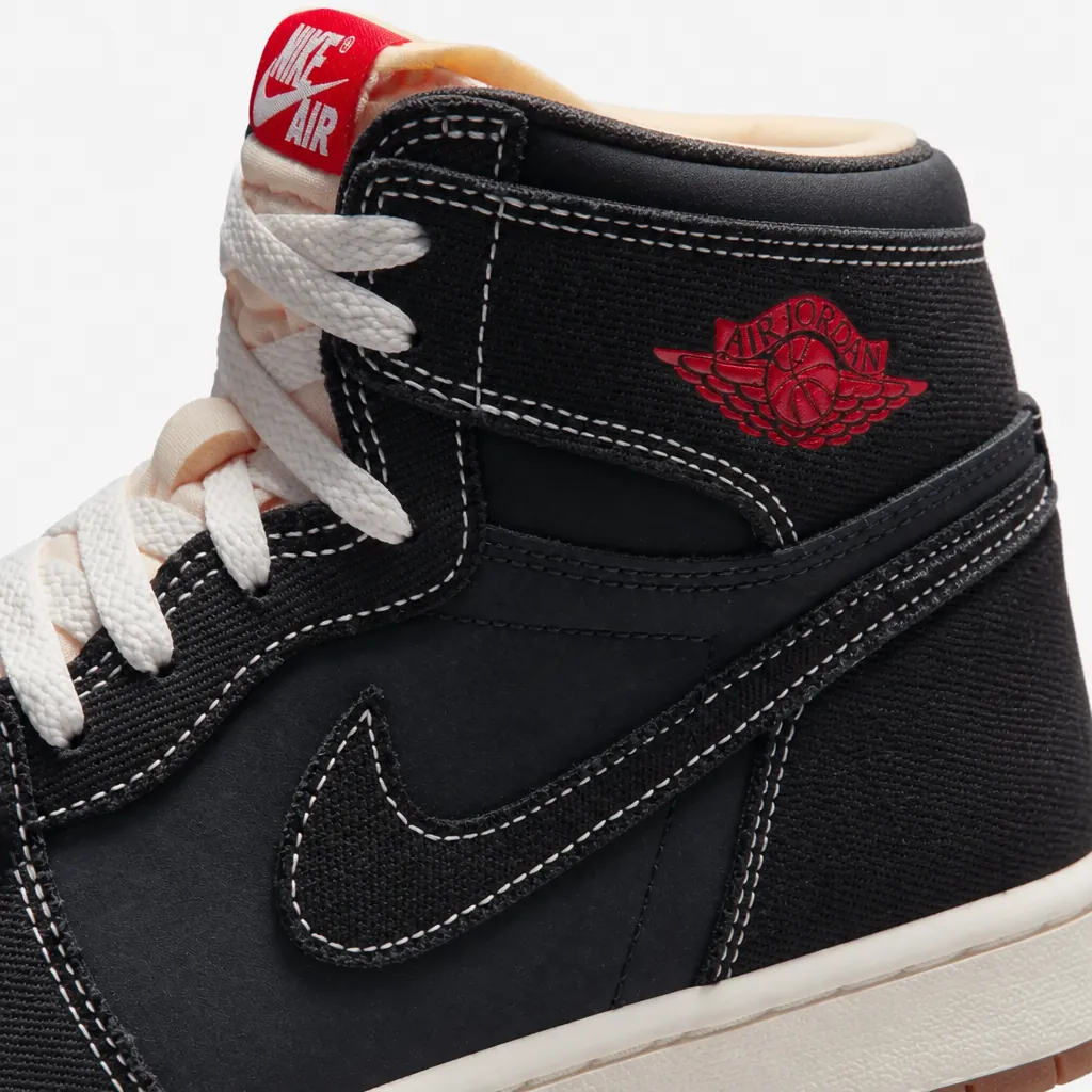 Side profile view of Air Jordan 1 showing the black woven textile upper texture and clean silhouette
